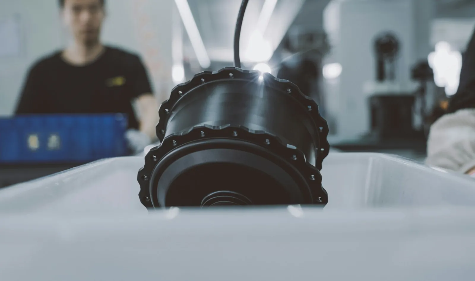 A partially assembled hub motor positioned on a production line