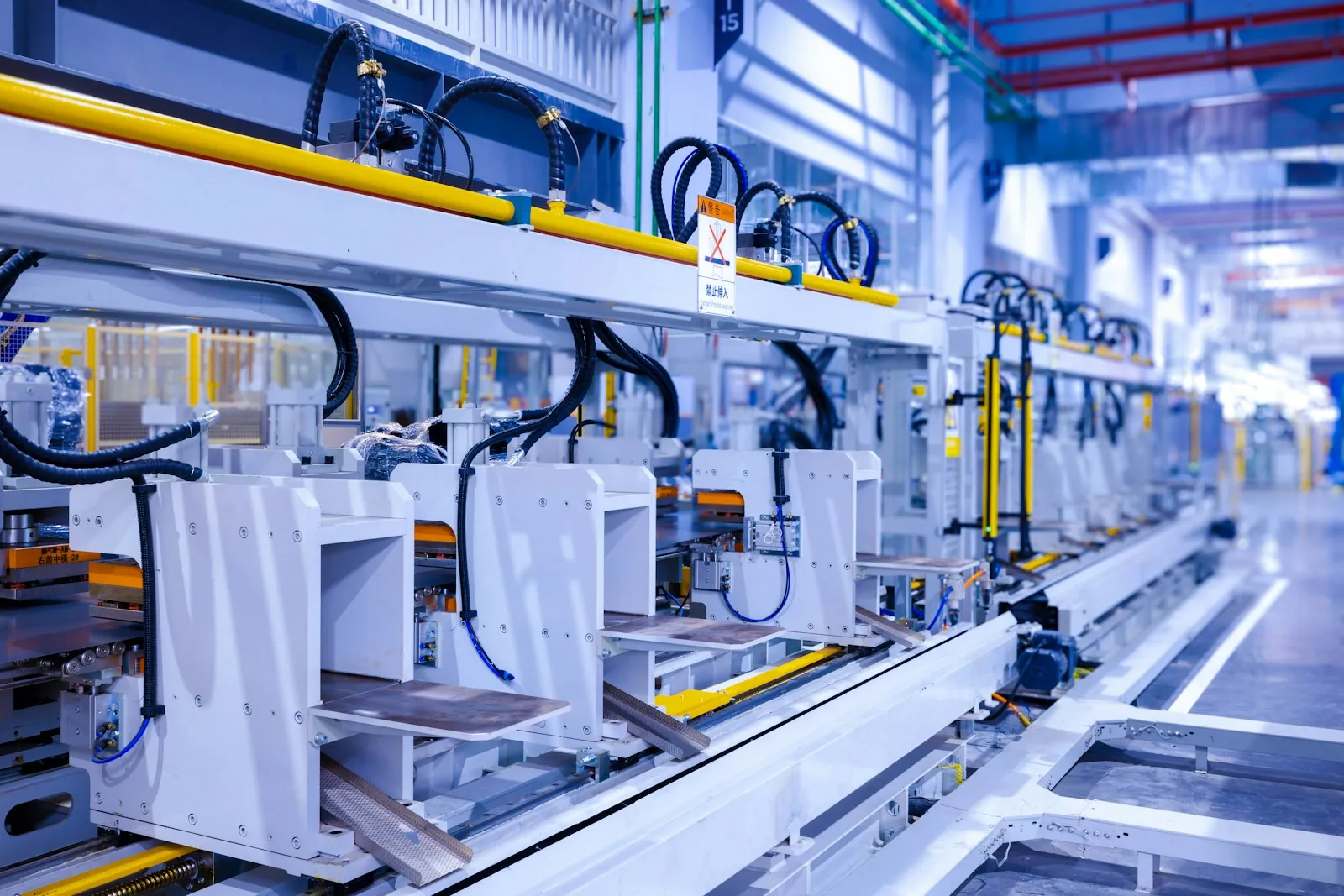 Automated production equipment and workstations inside a manufacturing facility