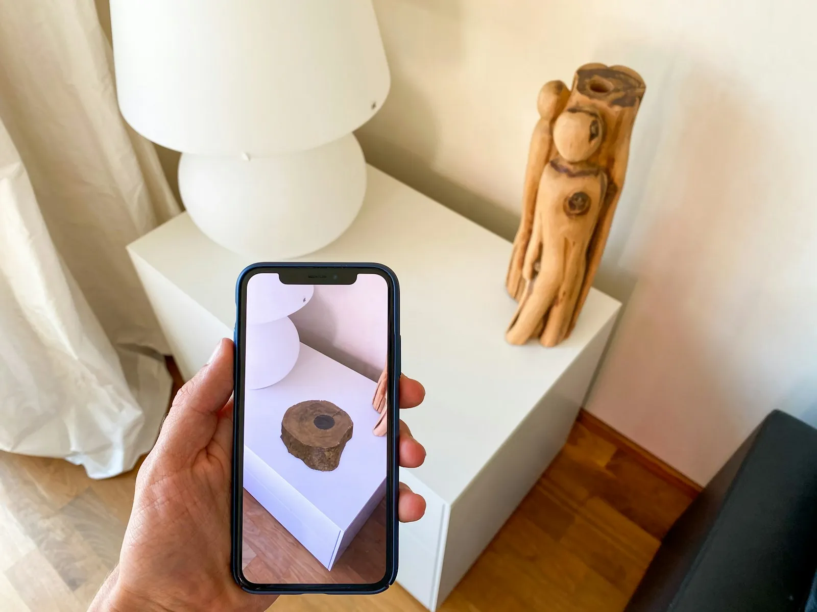 A smartphone showing a virtual object over a real tabletop through its camera view